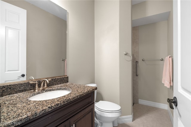 bathroom featuring vanity, tile patterned floors, and toilet