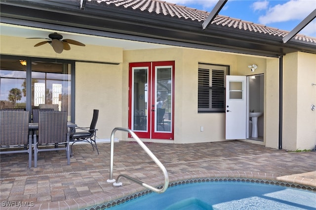 view of swimming pool featuring ceiling fan, sink, and a patio area