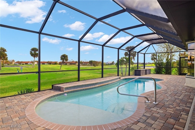 view of pool with a lawn, a lanai, and a patio area