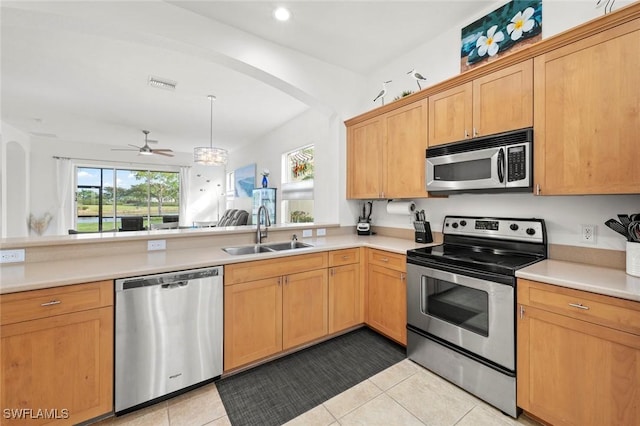 kitchen with appliances with stainless steel finishes, sink, kitchen peninsula, light tile patterned flooring, and ceiling fan