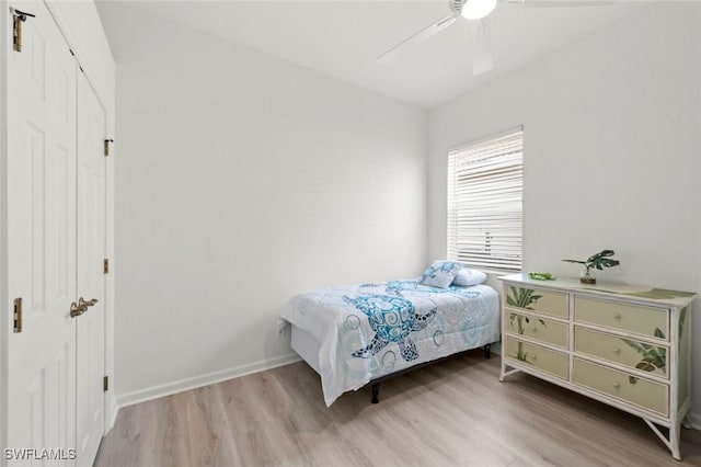 bedroom featuring ceiling fan, light wood-type flooring, and a closet