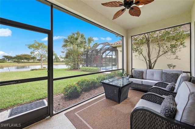 sunroom / solarium featuring ceiling fan and a water view