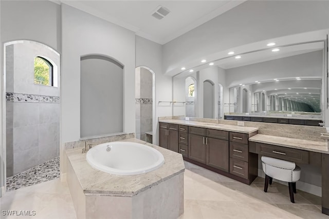 bathroom featuring ornamental molding, separate shower and tub, and vanity