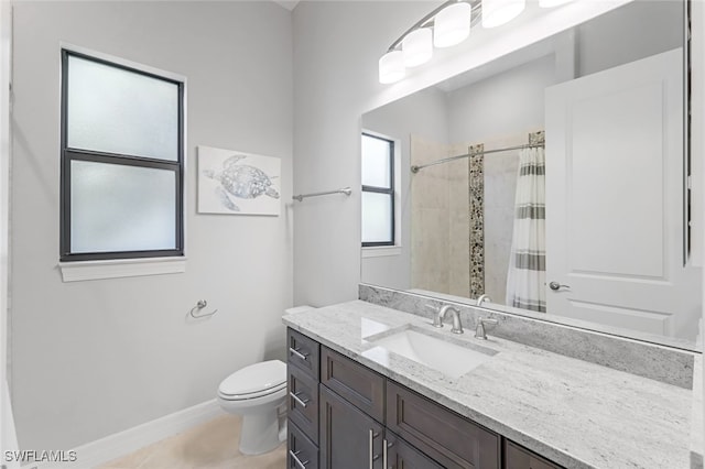 bathroom featuring toilet, vanity, tile patterned flooring, and a shower with curtain