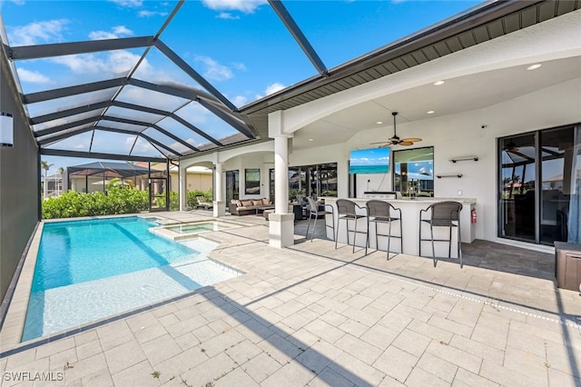 view of pool featuring an outdoor bar, a patio area, an in ground hot tub, and outdoor lounge area