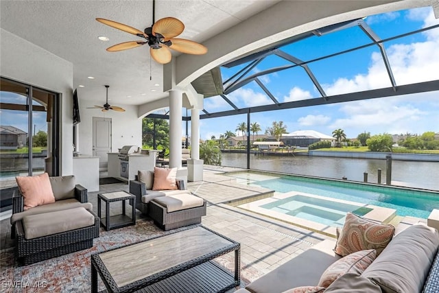 view of patio with exterior kitchen, an outdoor living space, ceiling fan, and glass enclosure