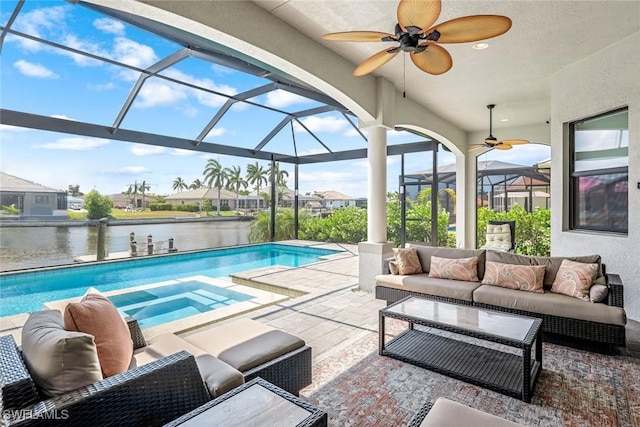 view of pool with a lanai, a patio, an outdoor living space, ceiling fan, and a water view