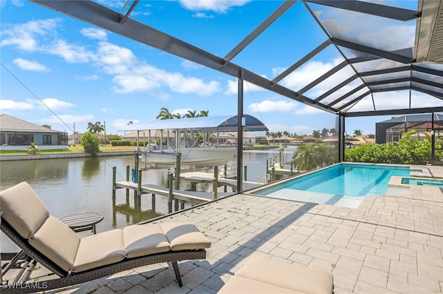 view of pool featuring glass enclosure, a boat dock, and a water view