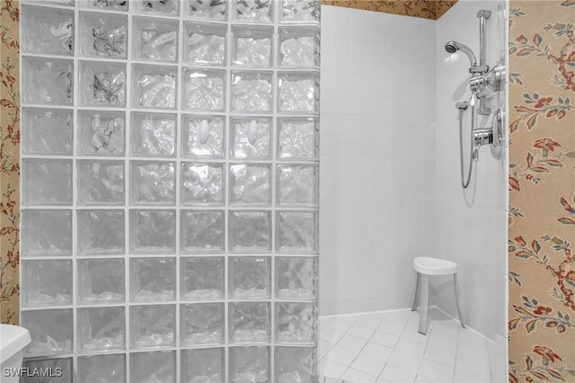 bathroom featuring tiled shower and tile patterned floors