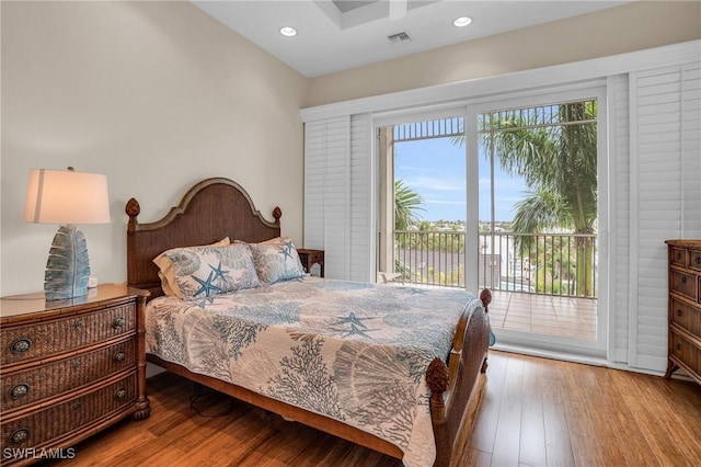 bedroom featuring wood-type flooring and access to exterior