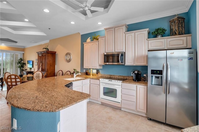 kitchen featuring a raised ceiling, crown molding, kitchen peninsula, and appliances with stainless steel finishes