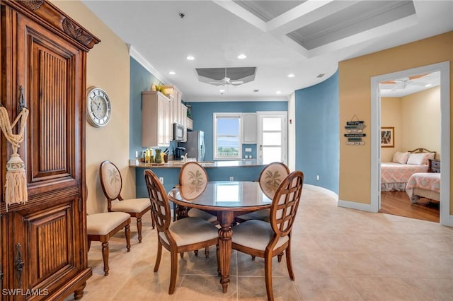 tiled dining room with ceiling fan, ornamental molding, and coffered ceiling