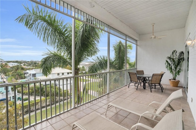 sunroom featuring ceiling fan