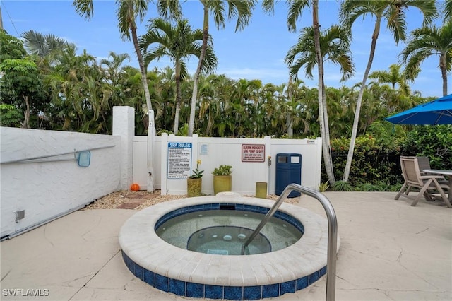 view of pool featuring a community hot tub and a patio