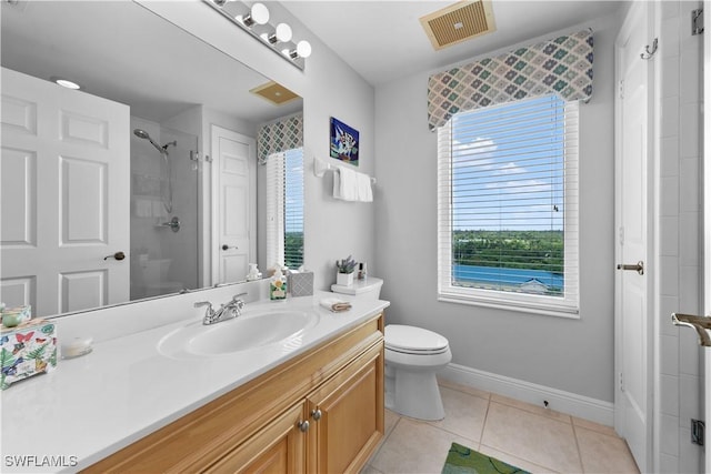 bathroom with walk in shower, vanity, tile patterned floors, and toilet