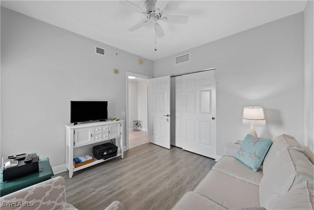 living room featuring light wood-type flooring and ceiling fan