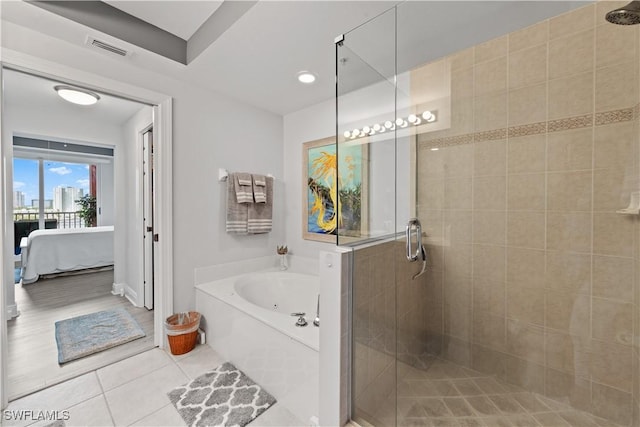 bathroom featuring tile patterned floors and independent shower and bath