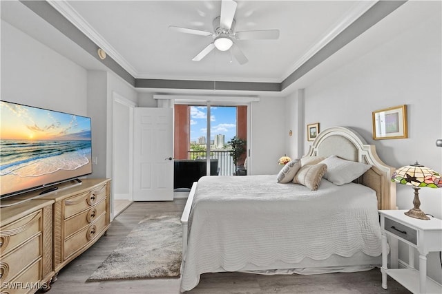 bedroom featuring ceiling fan, light hardwood / wood-style flooring, crown molding, and access to exterior