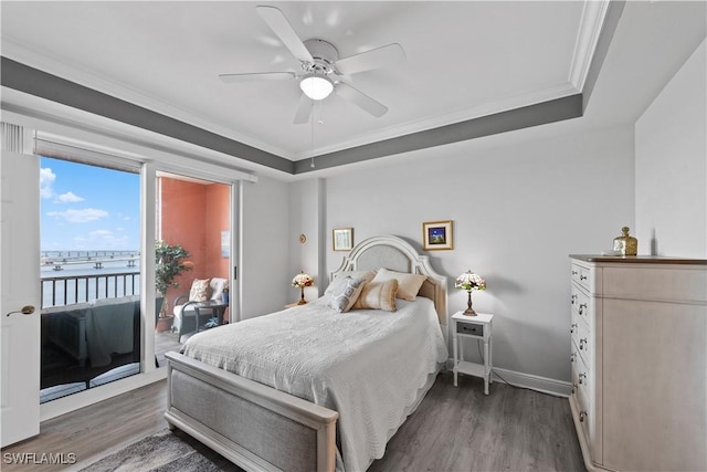 bedroom featuring ceiling fan, dark hardwood / wood-style flooring, ornamental molding, and a tray ceiling