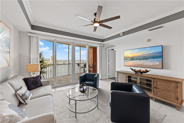 living room with ornamental molding, ceiling fan, and light tile patterned floors