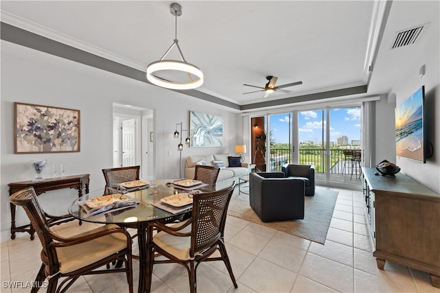 dining room featuring ornamental molding, light tile patterned flooring, and ceiling fan