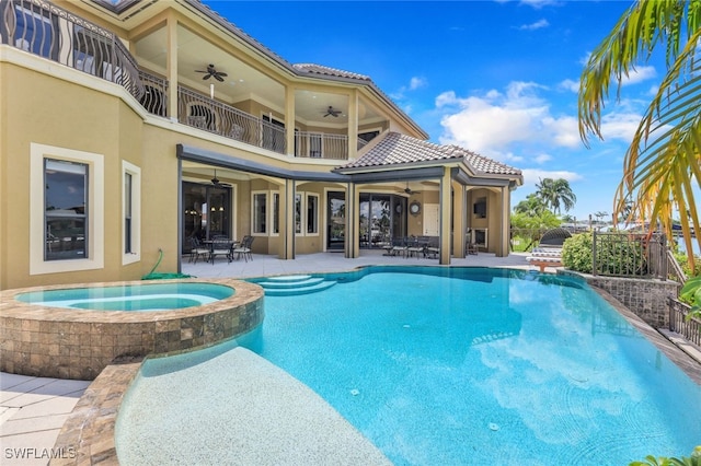 view of pool with ceiling fan, a patio, and an in ground hot tub