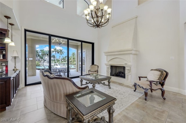 living room featuring a towering ceiling and an inviting chandelier