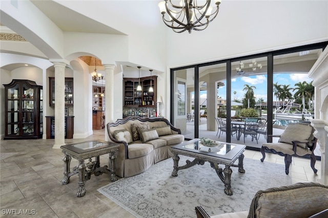 living room featuring decorative columns and a chandelier