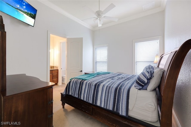 carpeted bedroom featuring ensuite bath, ceiling fan, and ornamental molding