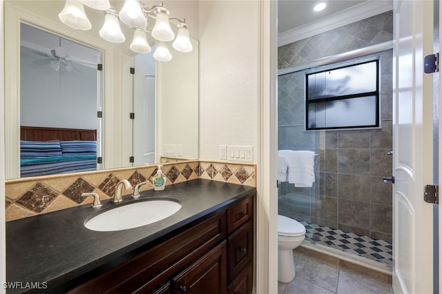 bathroom featuring toilet, crown molding, tile patterned floors, vanity, and ceiling fan