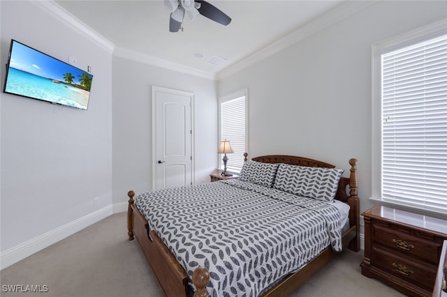 carpeted bedroom with multiple windows, ceiling fan, and ornamental molding