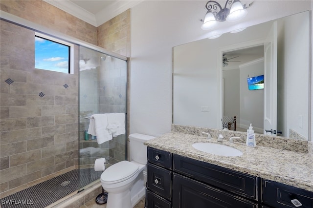 bathroom featuring toilet, crown molding, vanity, ceiling fan, and an enclosed shower