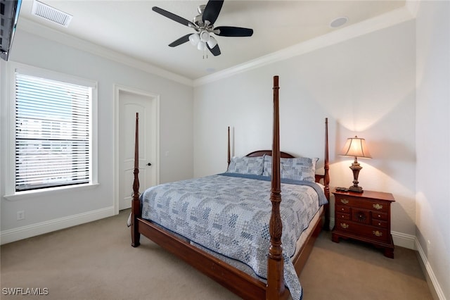 carpeted bedroom with ceiling fan and crown molding