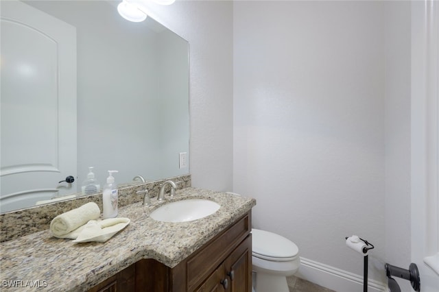 bathroom featuring toilet and vanity