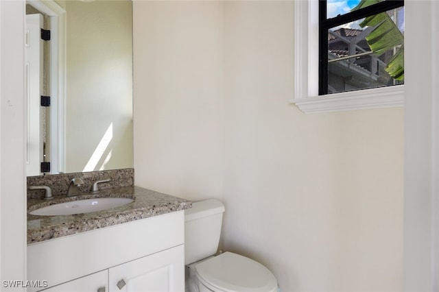 bathroom with vanity and toilet