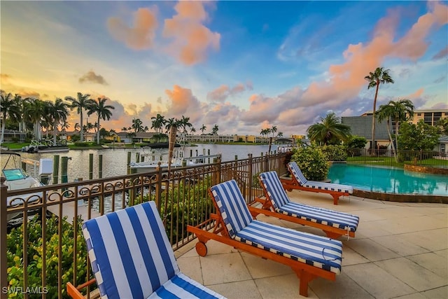 exterior space featuring a boat dock, a community pool, and a water view