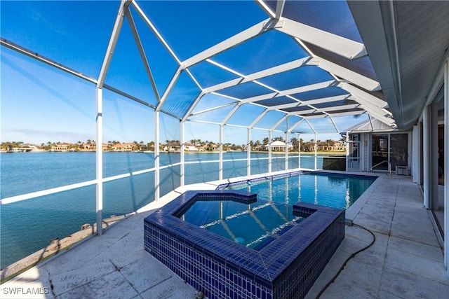 view of pool with a lanai, a patio, a water view, and an in ground hot tub