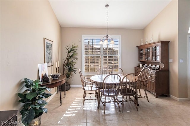 tiled dining area with a chandelier