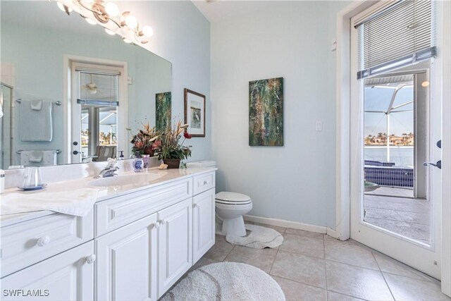 bathroom with vanity, tile patterned flooring, and toilet