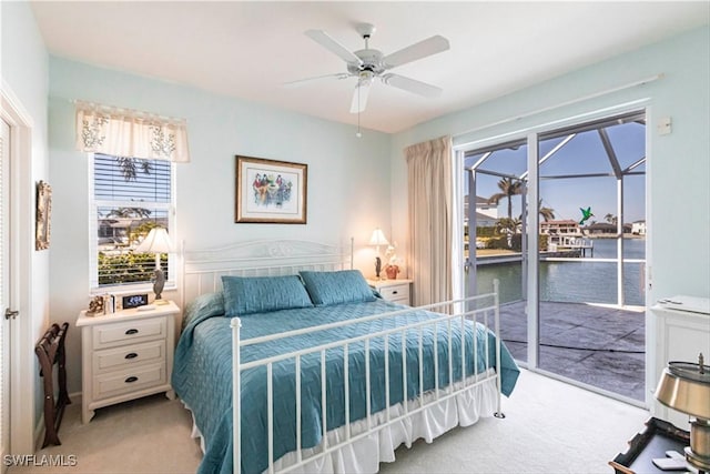 bedroom with ceiling fan, light carpet, and access to exterior