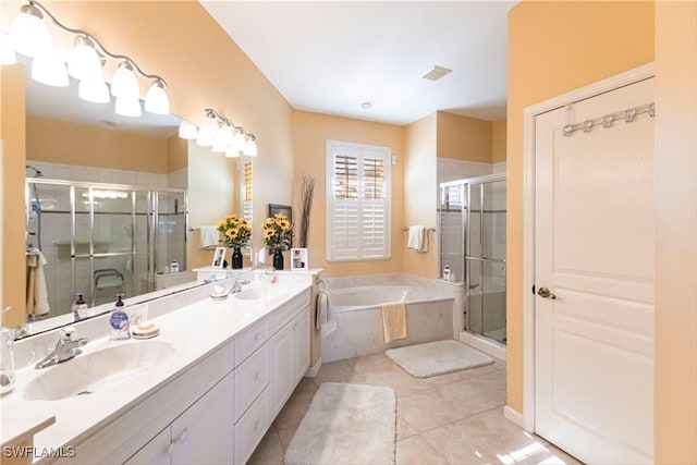 bathroom featuring shower with separate bathtub, vanity, and tile patterned floors