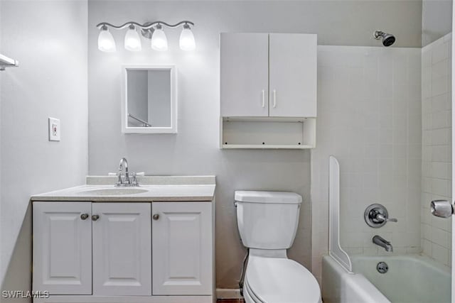 full bathroom featuring toilet, tiled shower / bath combo, and vanity