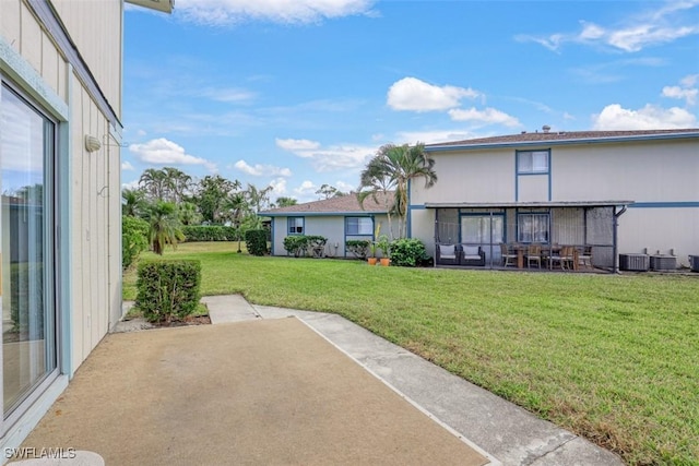 view of yard with central AC unit and a patio area