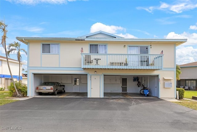 view of property featuring a balcony and a garage