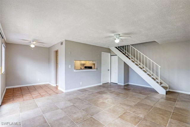 unfurnished living room featuring ceiling fan, a textured ceiling, and light tile patterned flooring