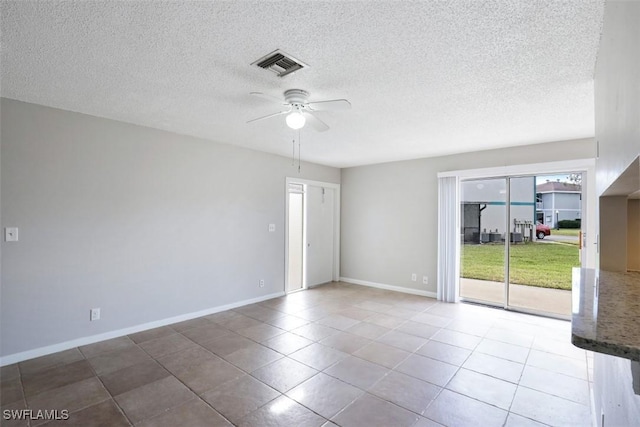 spare room featuring ceiling fan and tile patterned floors