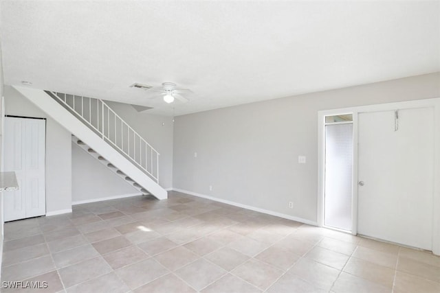 interior space with ceiling fan and light tile patterned floors