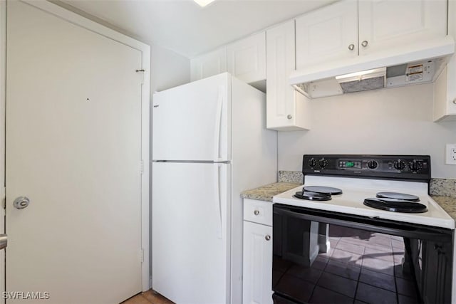 kitchen with electric stove, white refrigerator, and white cabinetry