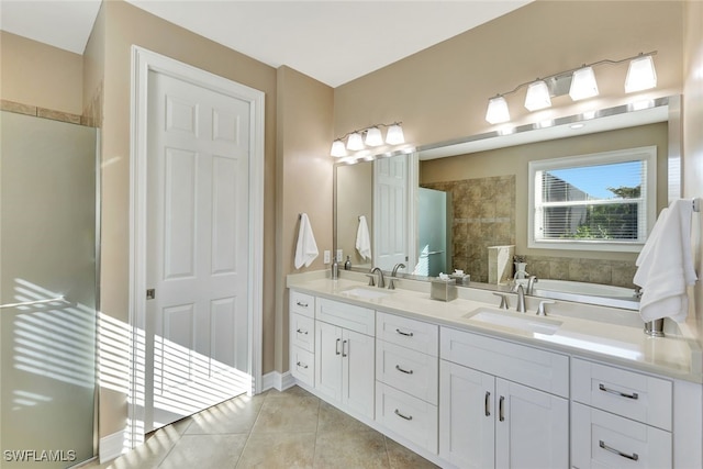 bathroom featuring a tub to relax in, vanity, and tile patterned floors