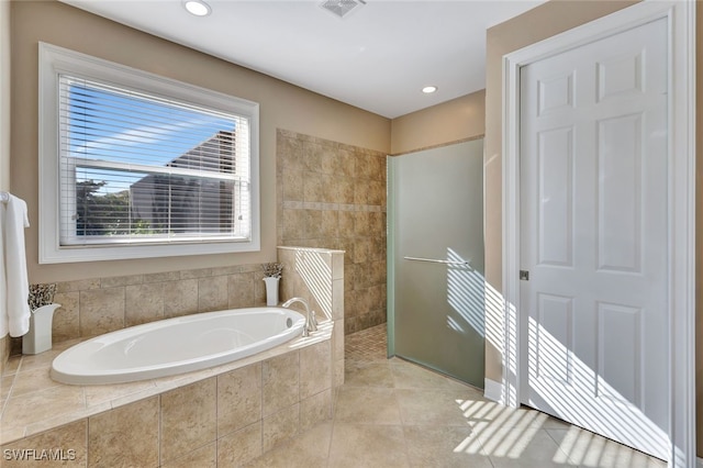 bathroom with separate shower and tub and tile patterned flooring